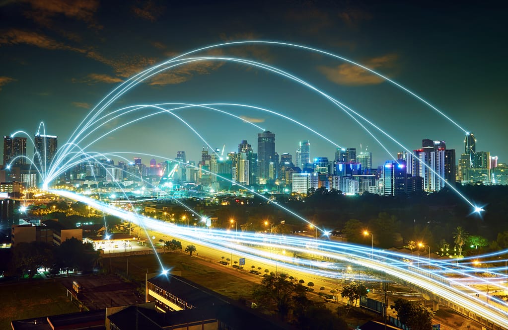 Smart City Development Using Digital Twin Technology showing lines of data flowing through Infrastructure and Buildings