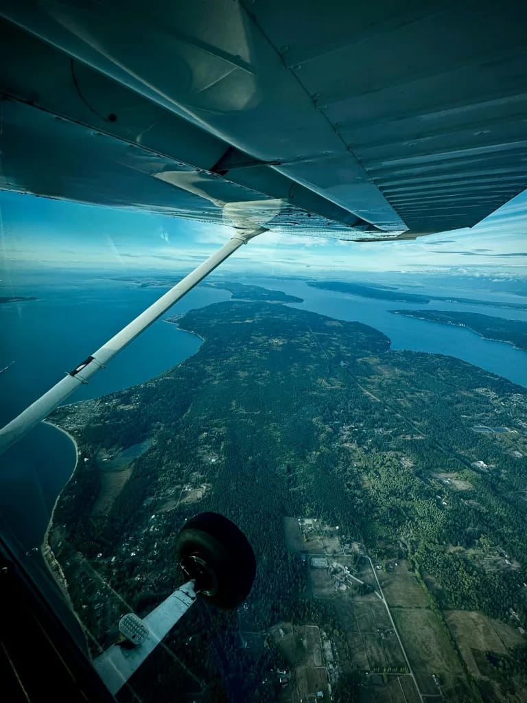 Fixed-wing plane surveying aircraft capturing national-scale LiDAR data over varied terrain